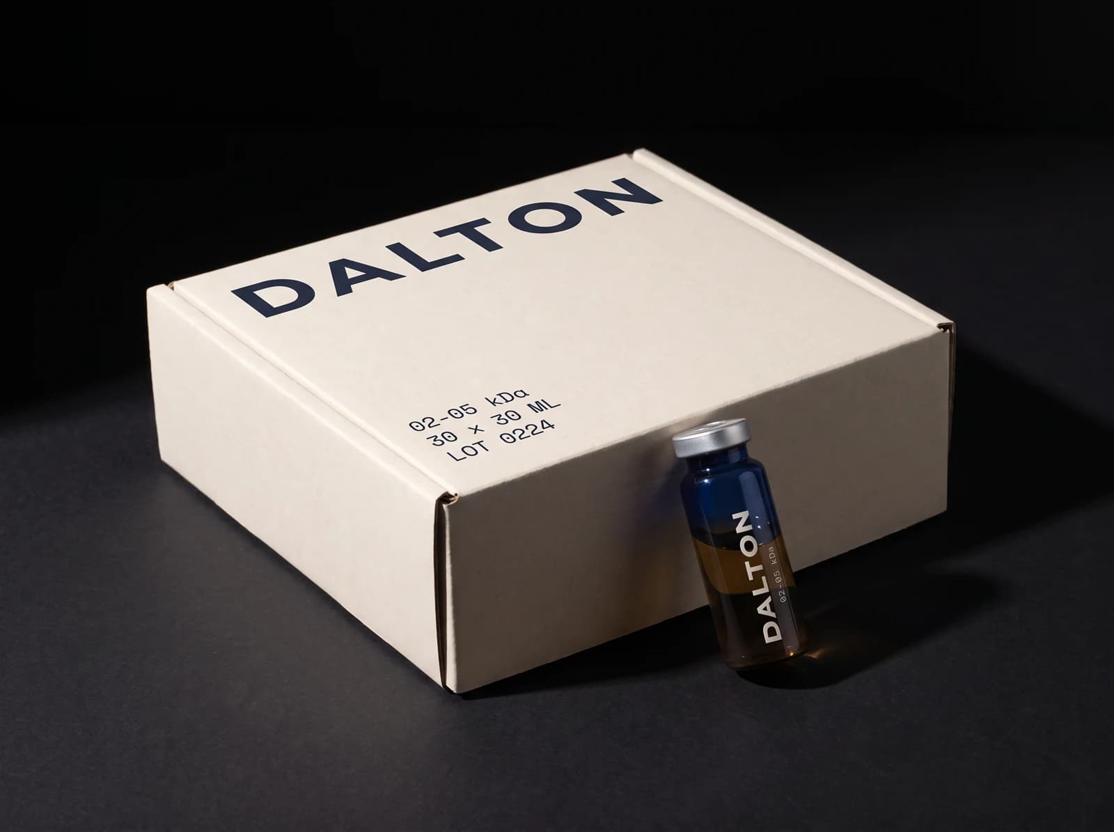 The closed thirty-dose DALTON box, wordmark on the lid, one vial resting against it.